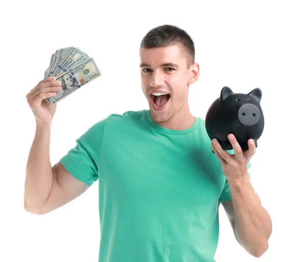 Handsome young man with dollars and piggy bank on white background — Stock Photo, Image