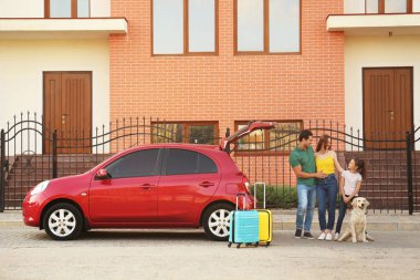 Sokakta araba yakınında köpek ile Mutlu aile