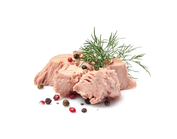 Pieces of canned tuna with dill and pepper on white background — Stock Photo, Image