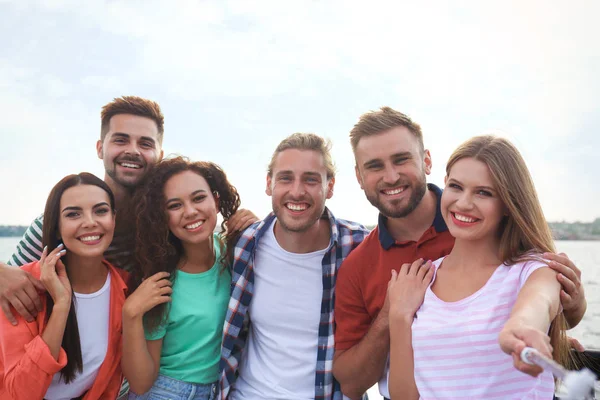 Happy young people taking selfie outdoors on sunny day — Stock Photo, Image