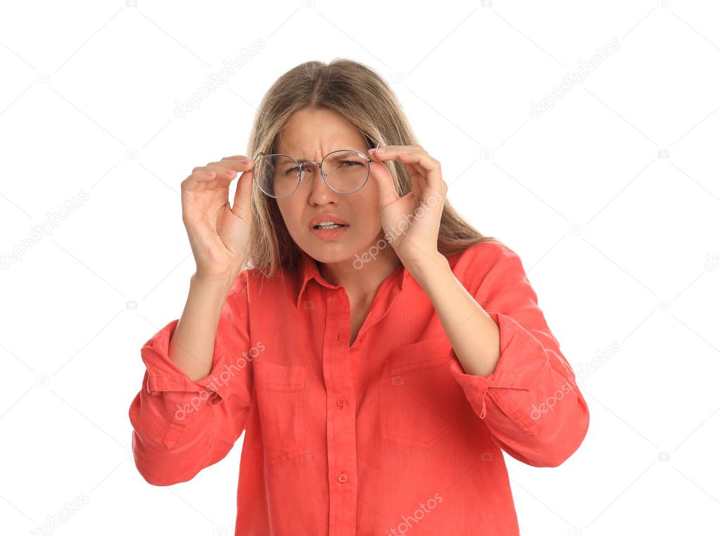 Young woman with vision problems wearing glasses on white background