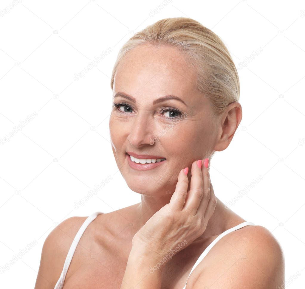 Portrait of beautiful mature woman with perfect skin on white background