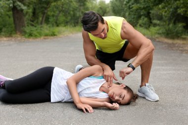 Genç adam parkta bilinçsiz kadının nabzını kontrol