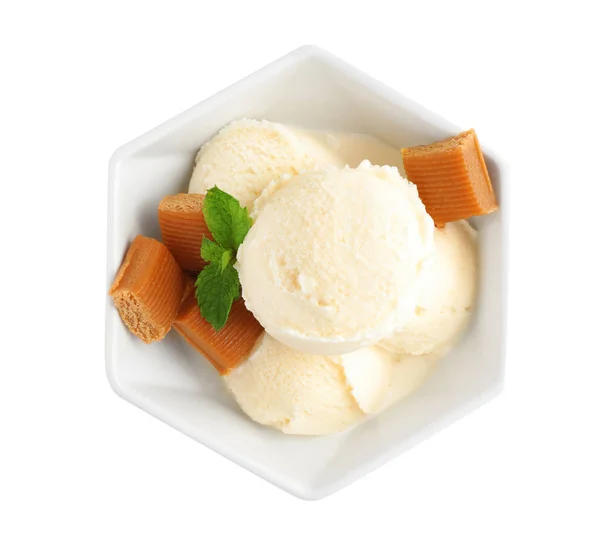 Bowl of ice cream with caramel candies and mint on white background, top view — Stock Photo, Image