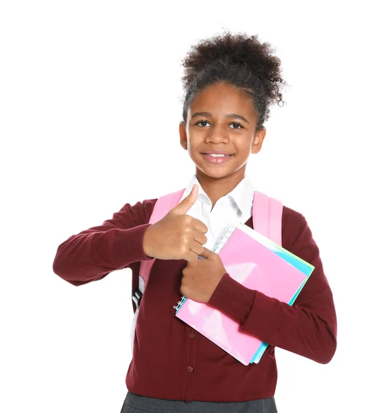 Lycklig afro-amerikansk flicka i skoluniform på vit bakgrund — Stockfoto