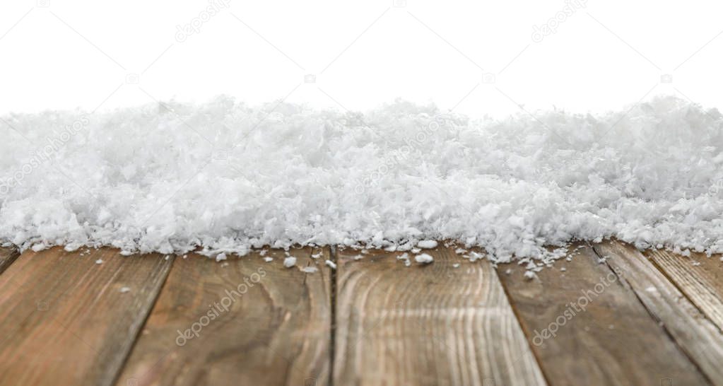 Heap of snow on wooden table against white background. Christmas season