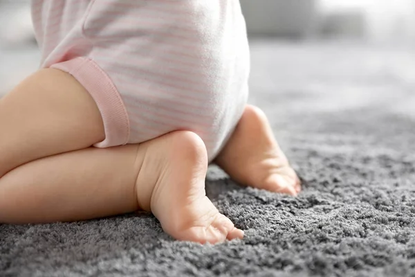 Closeup view of little baby on soft grey carpet — Stock Photo, Image