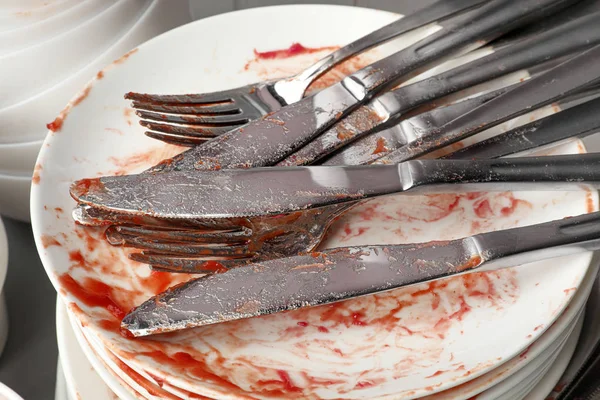 Stack of dirty dishes with cutlery, closeup — Stock Photo, Image