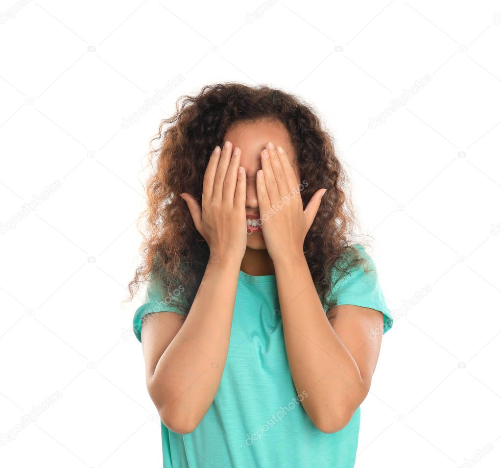 Young African-American woman being blinded on white background