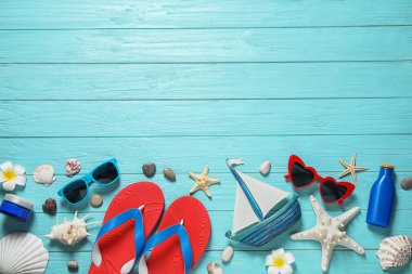 Açık mavi ahşap arka plan üzerinde şık plaj aksesuarları ile Düz döşeme kompozisyon, metin için alan