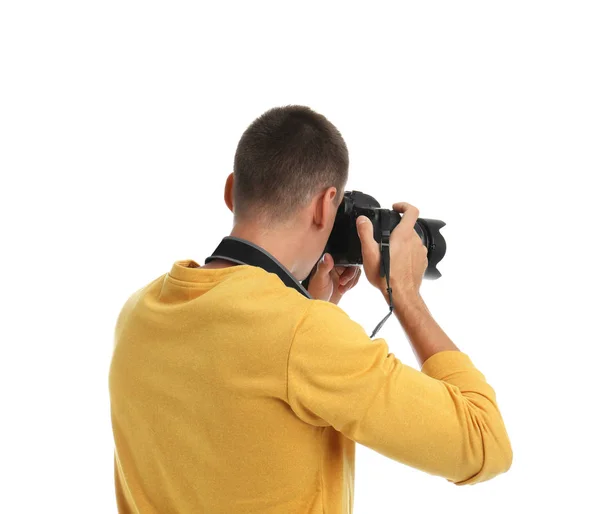 Joven fotógrafo con cámara profesional sobre fondo blanco, vista trasera —  Fotos de Stock