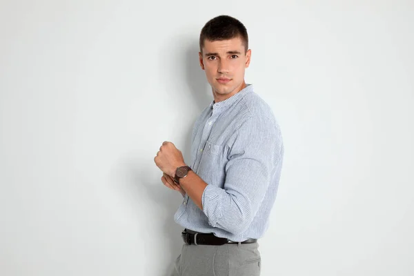 Portrait of handsome young man on light background