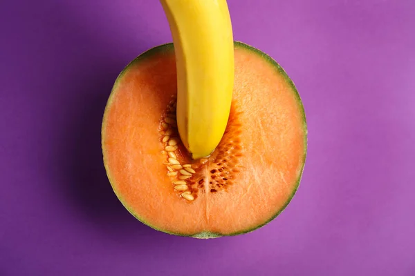 stock image Flat lay composition with fresh banana and melon on purple background. Sex concept