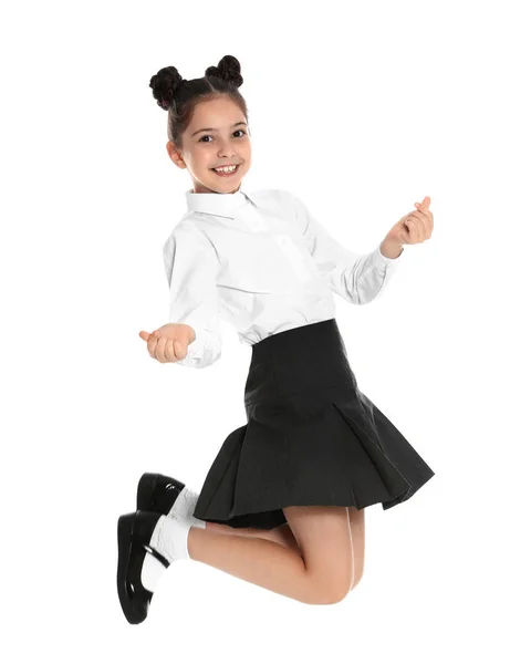 Chica feliz en uniforme escolar saltando sobre fondo blanco —  Fotos de Stock