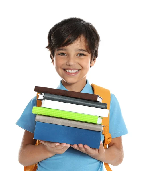 Lycklig pojke i skoluniform med högen av böcker på vit bakgrund — Stockfoto