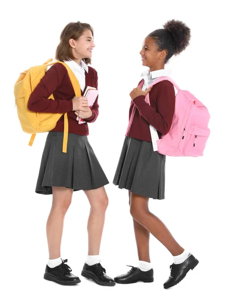 Boldog lányok az iskolai egyenruhát, fehér háttér — Stock Fotó