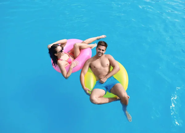 Donna in bikini con fidanzato che nuota al resort. Felice giovane coppia — Foto Stock