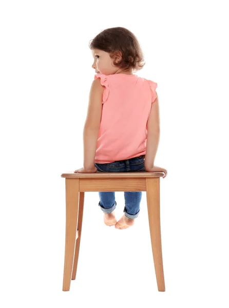 Little girl on stool against white background. Danger at home — Stock Photo, Image