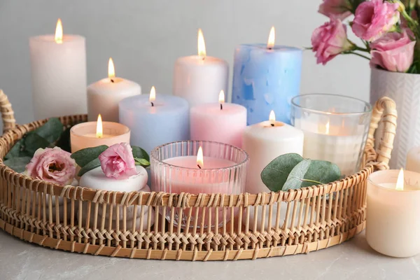 Composition with burning candles on light grey table — Stock Photo, Image