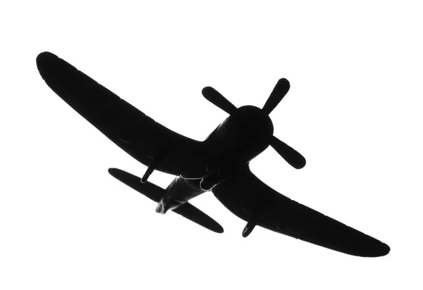 Temná silueta vojenského letounu hračky na bílém pozadí — Stock fotografie