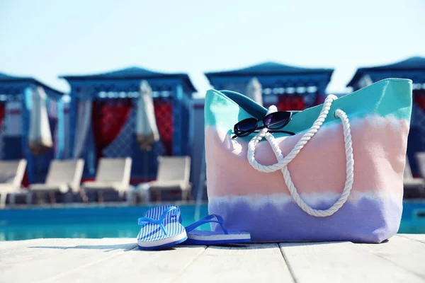 Accesorios de playa cerca de la piscina en un día soleado. Espacio para texto —  Fotos de Stock