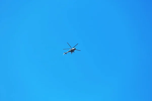 Modern military helicopter flying in blue sky