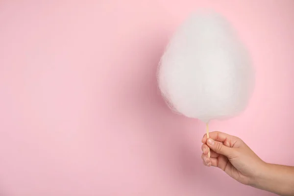 Woman holding sweet cotton candy on pink background, closeup view. Space for text — Stock Photo, Image