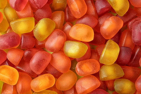 Dulces caramelos de gelatina de color como fondo, vista superior — Foto de Stock