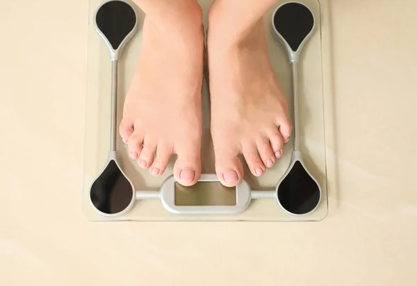 Woman standing on floor scales indoors, top view. Overweight problem — Stock Photo, Image