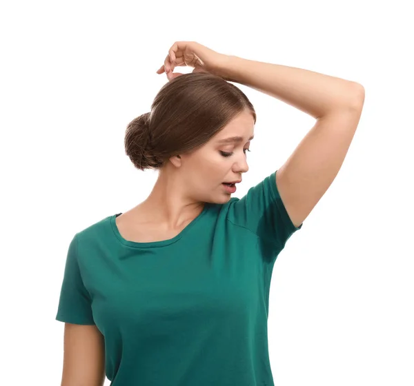 Young woman with sweat stain on her clothes against white background. Using deodorant — Stock Photo, Image