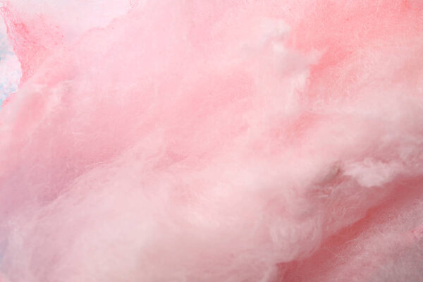 Sweet pink cotton candy as background, close seup view
