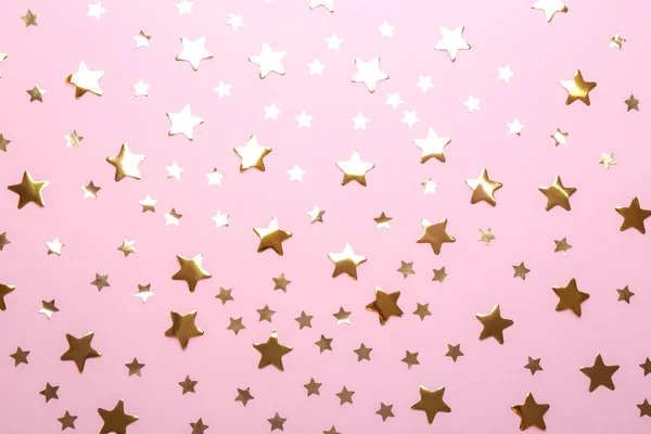 Confetti stars on pink background, flat lay. Christmas celebration — Stock Photo, Image