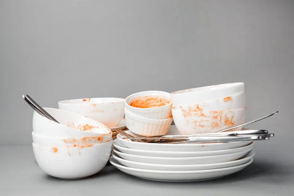 Set of dirty dishes on grey background — Stock Photo, Image