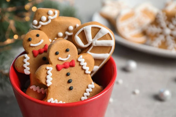 Tasty homemade Christmas cookies in cup on grey table, closeup view — Stock Photo, Image