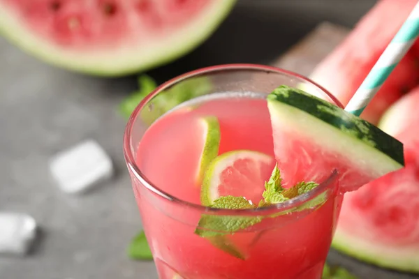 Glass of tasty refreshing drink with watermelon on grey table, closeup — Stock Photo, Image