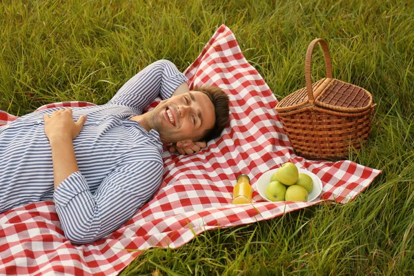 Fiatal férfi feküdt a piknik takaró parkban — Stock Fotó