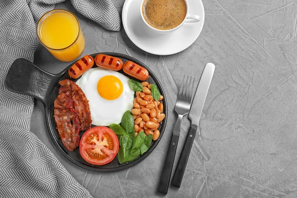 Delicious breakfast with fried egg served on grey table, flat lay. Space for text — Stock Photo, Image