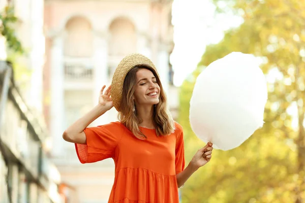 Glückliche junge Frau mit Zuckerwatte im Freien — Stockfoto