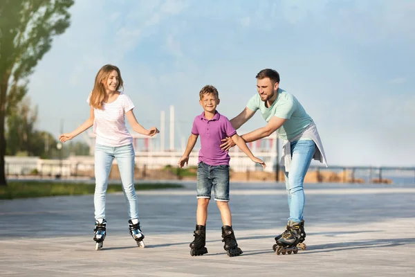 Happy family roller skating on city street