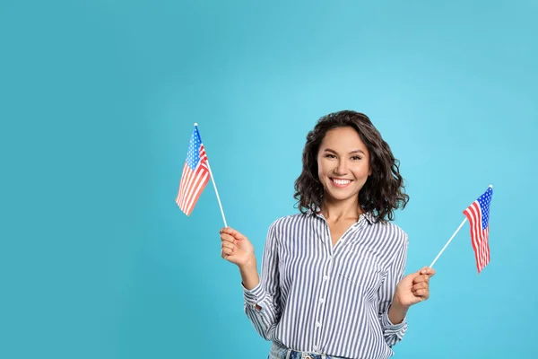 Happy young woman with USA flag on blue background. Space for text — Stock Photo, Image