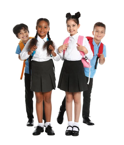 Glückliche Kinder in Schuluniform auf weißem Hintergrund — Stockfoto