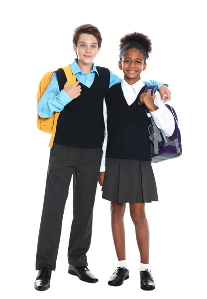 Alunos felizes em uniforme escolar em fundo branco — Fotografia de Stock