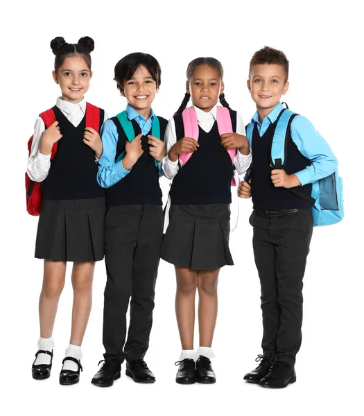 Ευτυχισμένα παιδιά με σχολική στολή σε λευκό φόντο — Φωτογραφία Αρχείου