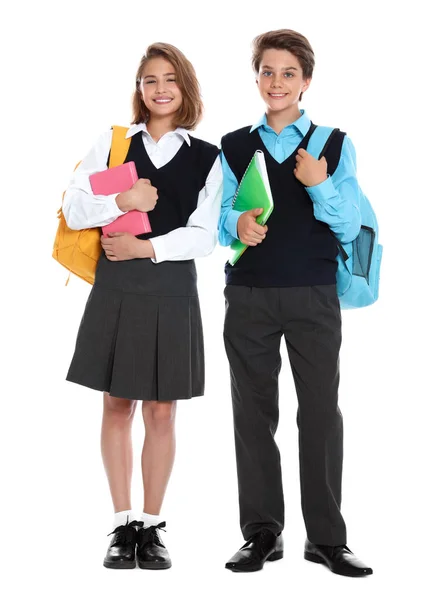 Alunos felizes em uniforme escolar em fundo branco — Fotografia de Stock