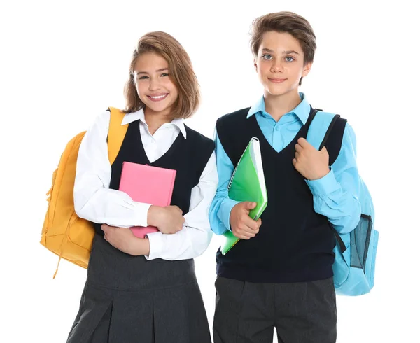 Alunos felizes em uniforme escolar em fundo branco — Fotografia de Stock