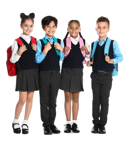 Glückliche Kinder in Schuluniform auf weißem Hintergrund — Stockfoto