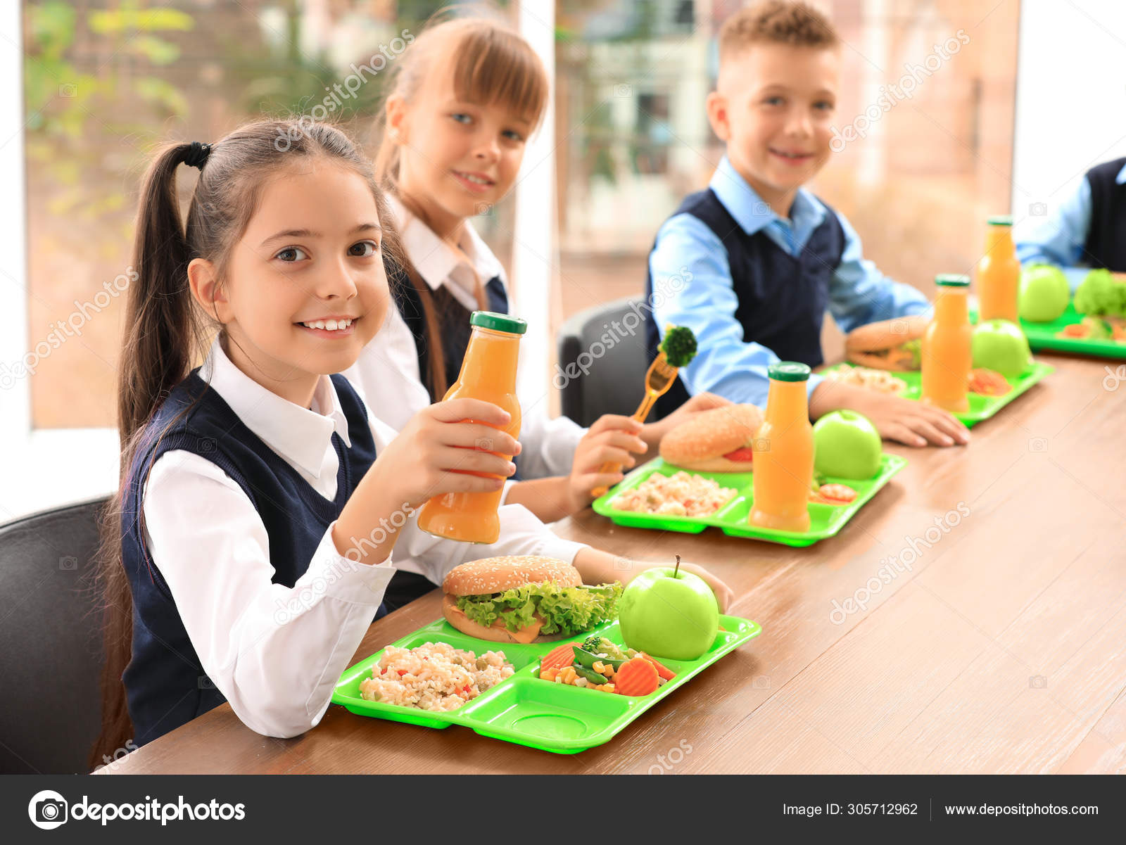 https://st4.depositphotos.com/16122460/30571/i/1600/depositphotos_305712962-stock-photo-happy-children-at-table-with.jpg