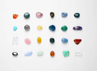 Different gemstones on white background, top view clipart