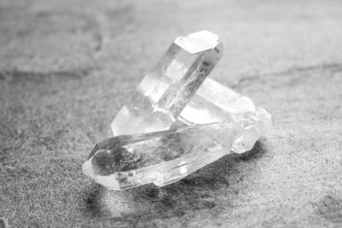 Beautiful rock crystal gemstones on grey table clipart