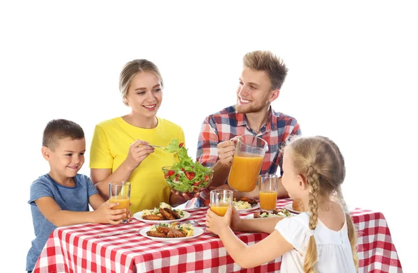 Família feliz fazendo piquenique à mesa no fundo branco — Fotografia de Stock